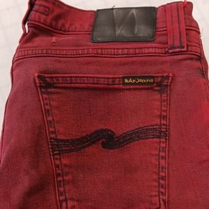 Red NUDIE jeans with black distressing. RAW HEM. size 29×32
